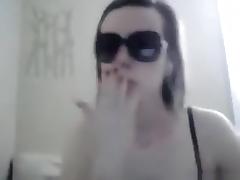 girl with sunglasses masturbates her shaved pussy closeup with a toy