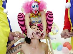 Provocative tattooed babe penetrated by a group of horny clowns