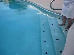 Corpulent granny in nylons plays in the pool